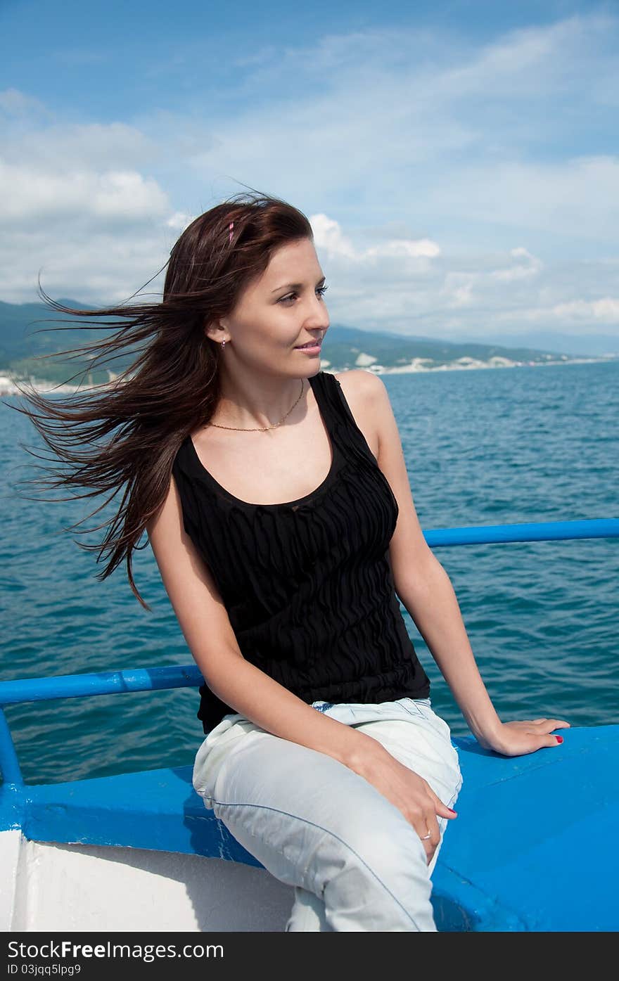 young woman on a yacht at sea