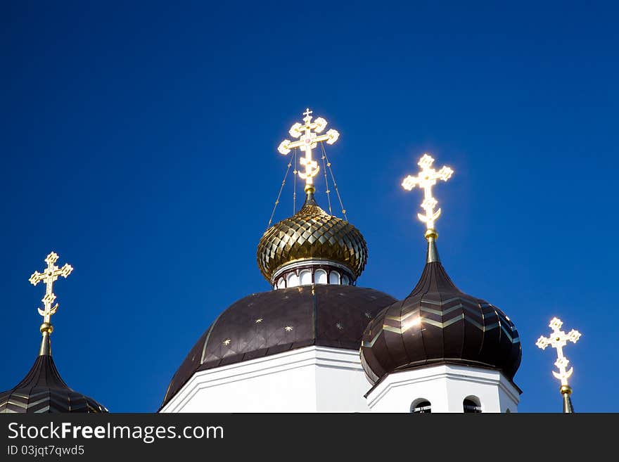 The crosses which are on domes of orthodox church, shone during a sunset (church of Transformations dominical in Belarus, the city of Smorgon). The crosses which are on domes of orthodox church, shone during a sunset (church of Transformations dominical in Belarus, the city of Smorgon)