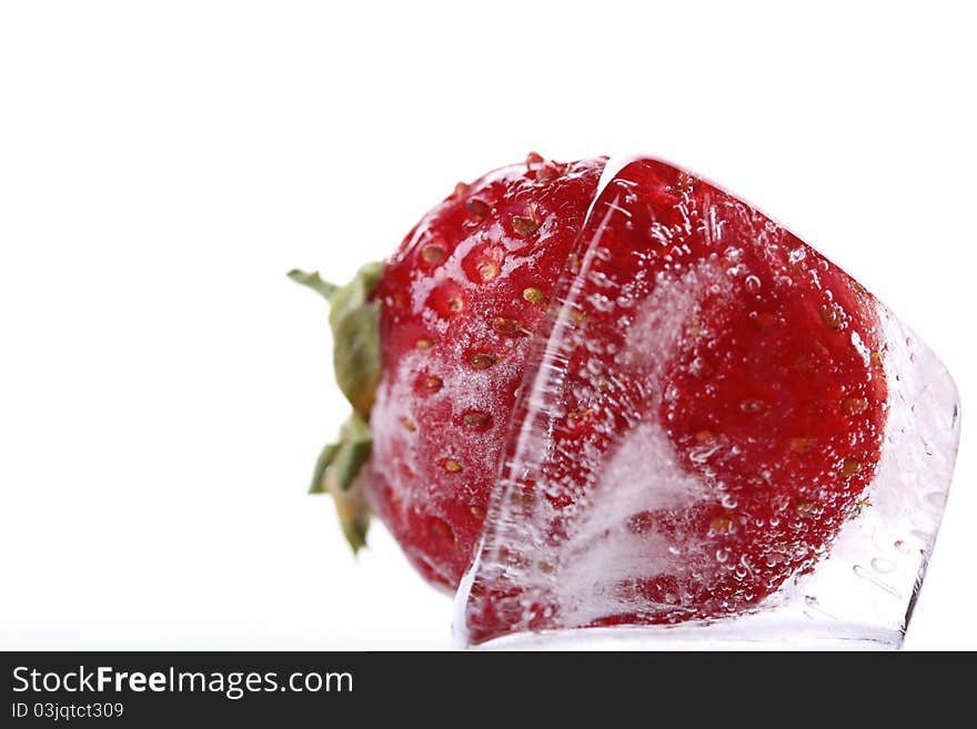 Close up ice cube with frozen strawberry isolated on a white background. Close up ice cube with frozen strawberry isolated on a white background