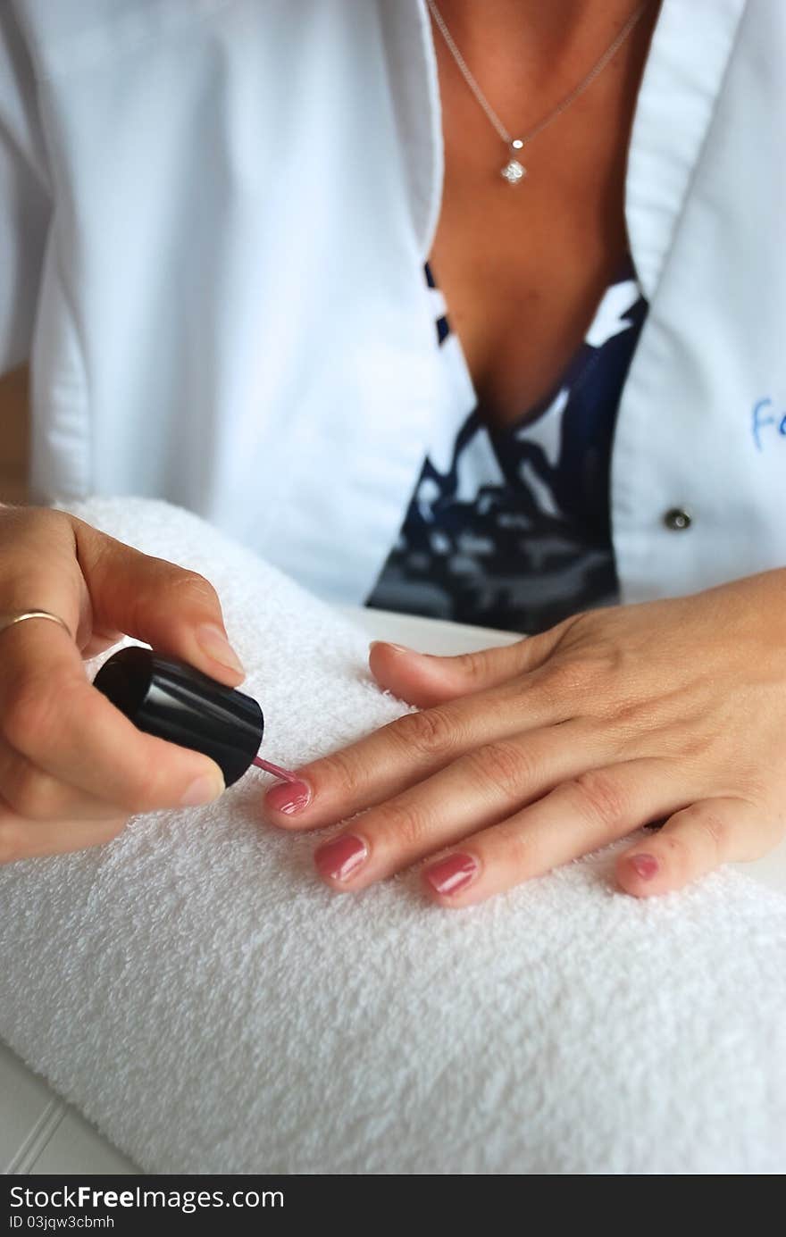 Woman using red nail polish. Woman using red nail polish