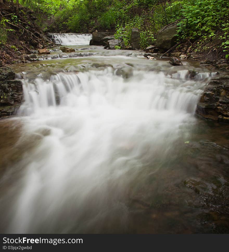 Small waterfall running through forest