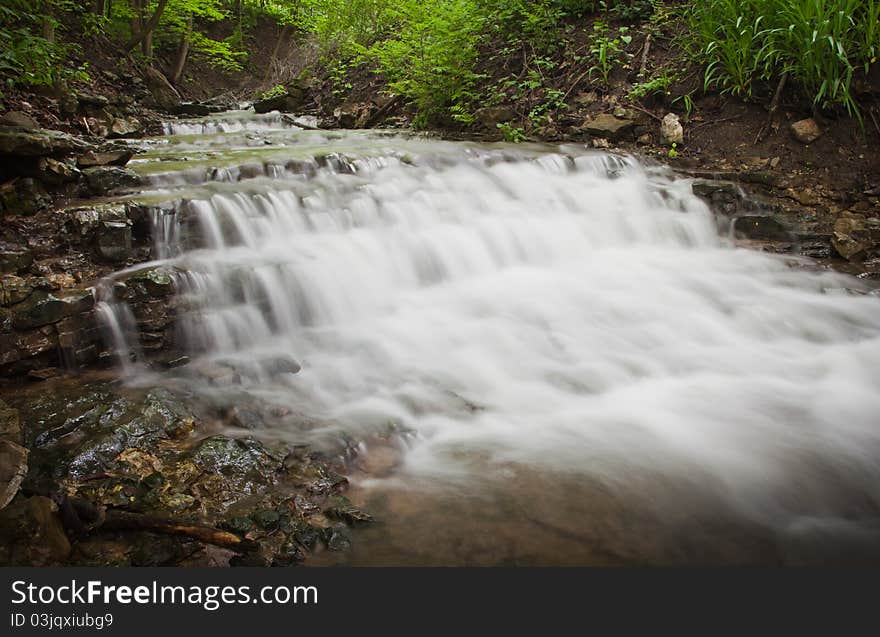 Small waterfall running through forest