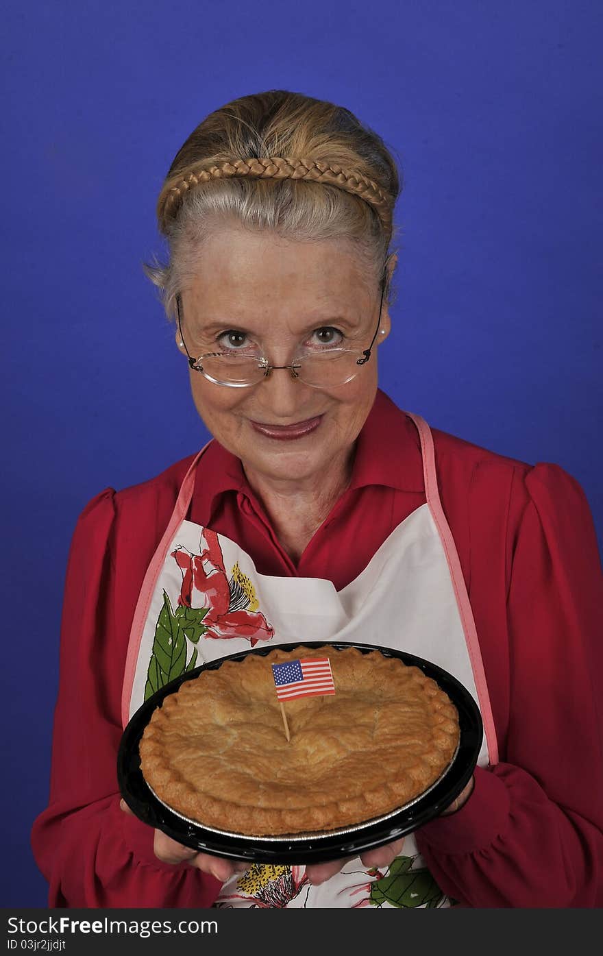 Senior grandmother offering a fresh apple pie. Senior grandmother offering a fresh apple pie