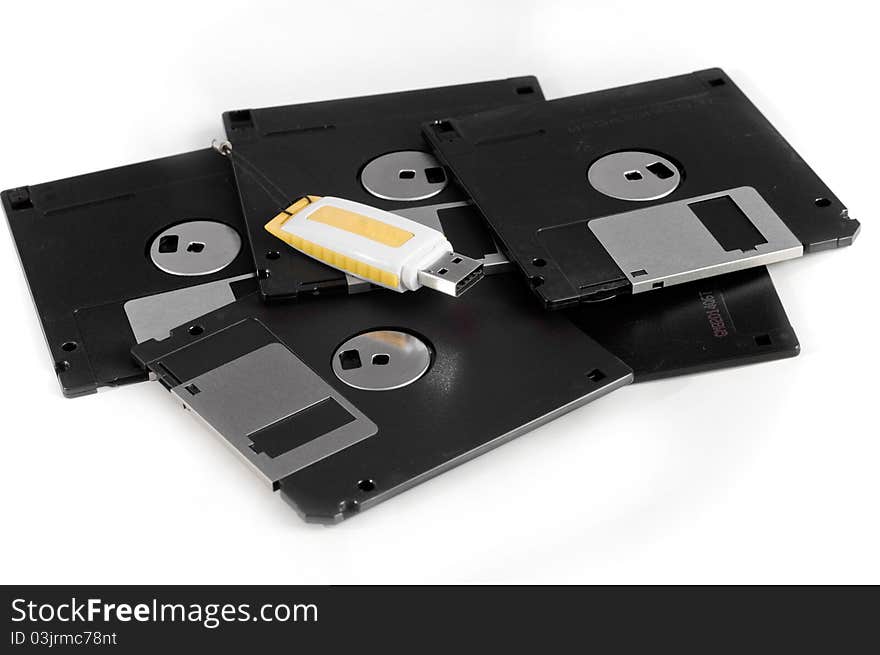 This image USB drive and floppy disk spiral on a white background. This image USB drive and floppy disk spiral on a white background