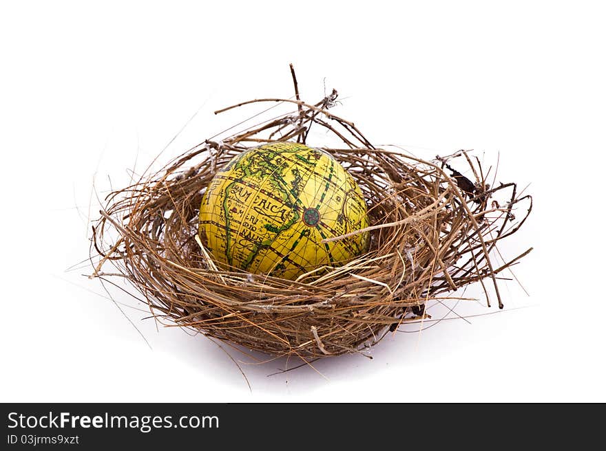 Birds nest with global inside, isolated on white.