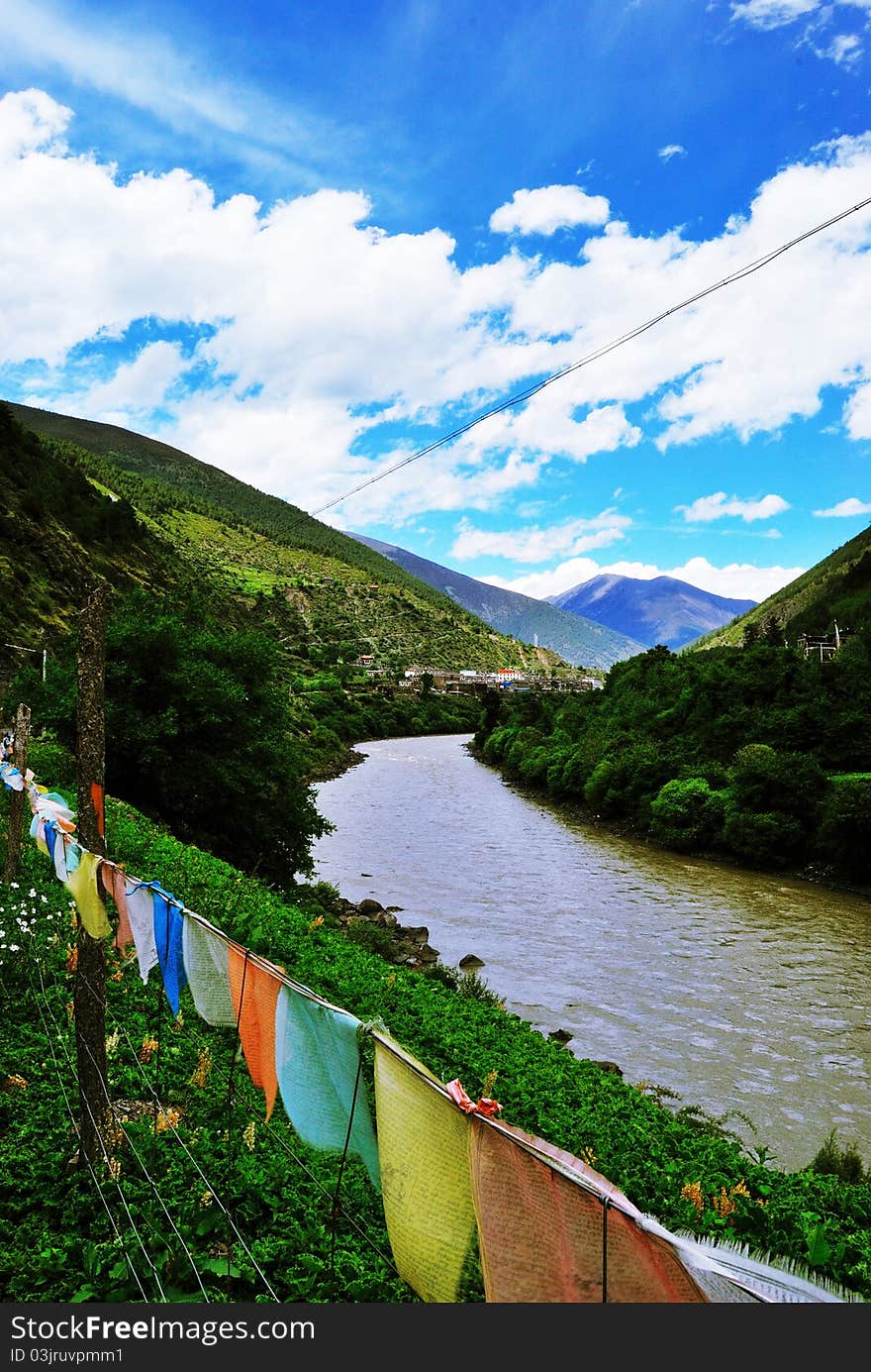 Harmony Western Sichuan Plateau,China  connect religious prayer flags with natural sky, river and hills.