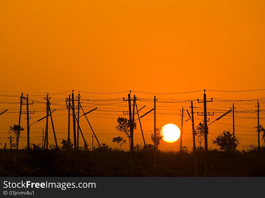 Sunrise from a electrical poles showing less trees and more poles. Sunrise from a electrical poles showing less trees and more poles