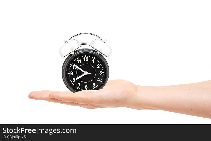 Woman with an alarm clock in a hand. Isolated on white background