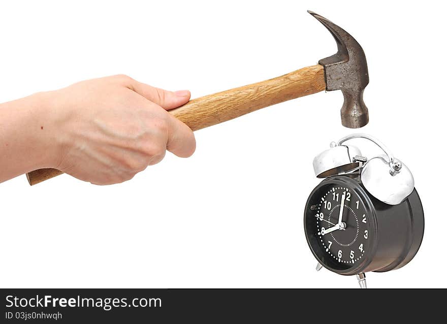 Hand holding a hammer about to hit the alarm clock