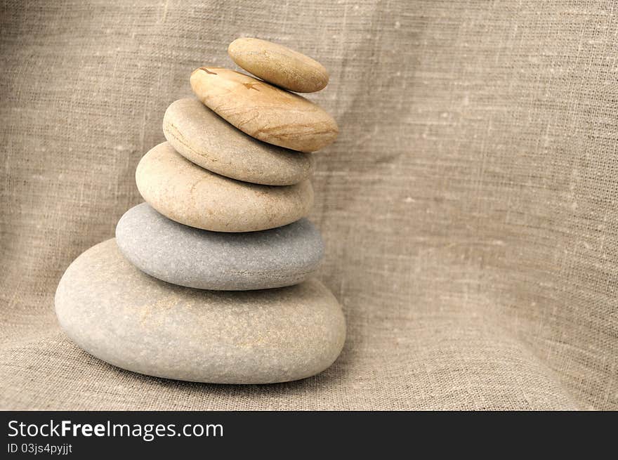 Pile of stones on a background of rough cloth