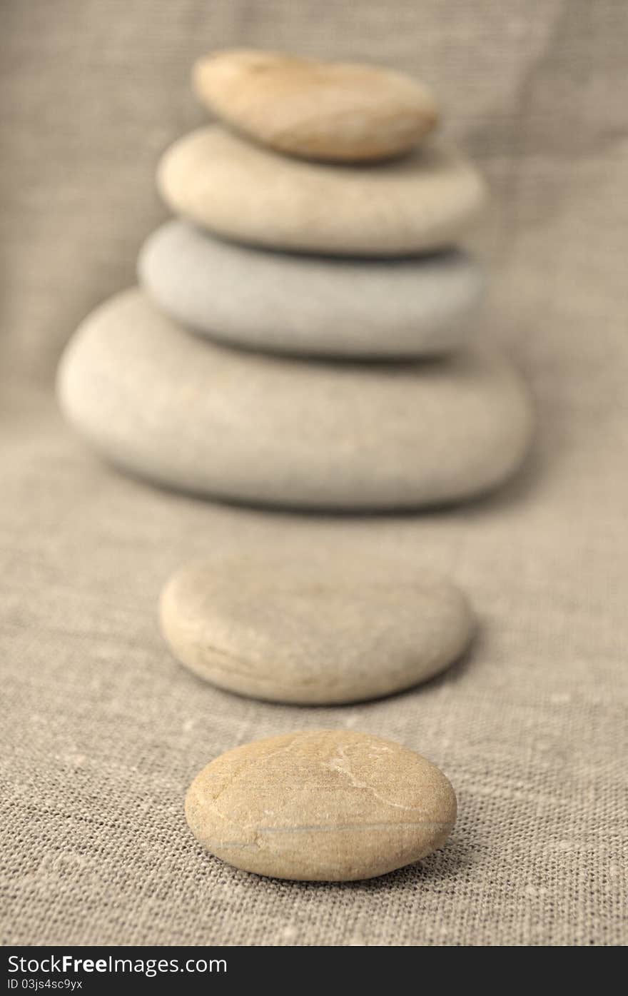 Pile of stones on a background of rough cloth