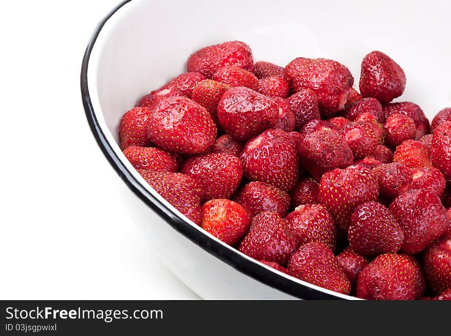 Clean strawberries in white bowl isolated on a background