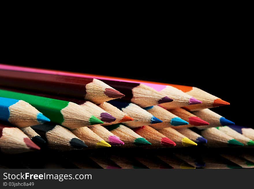 Many colors pencils isolated on a black background