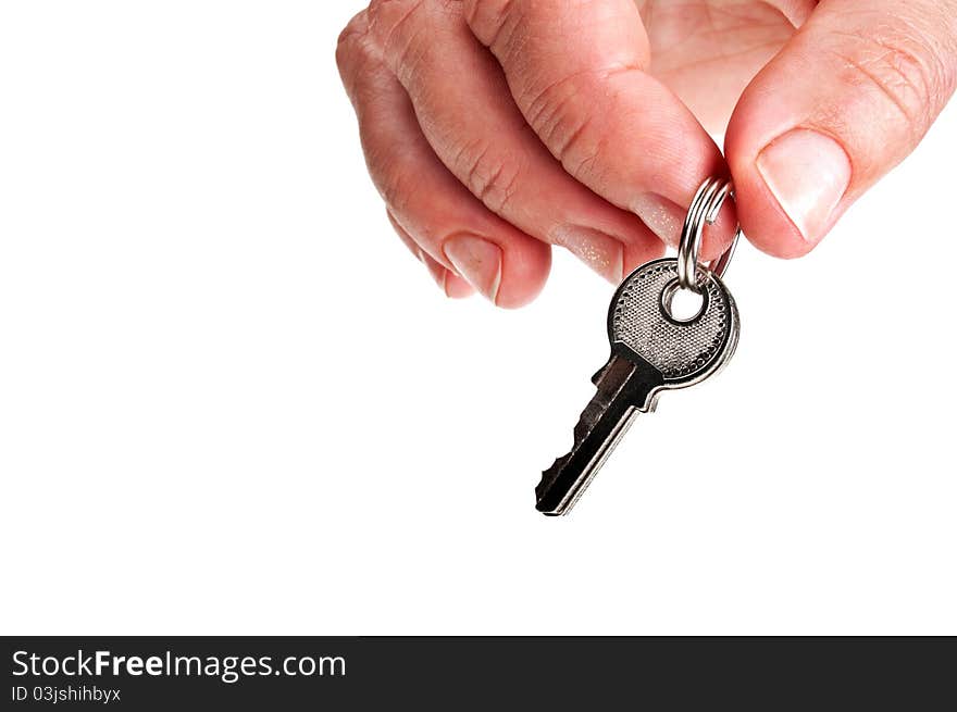 Three silver keys in a hand isolated on white background