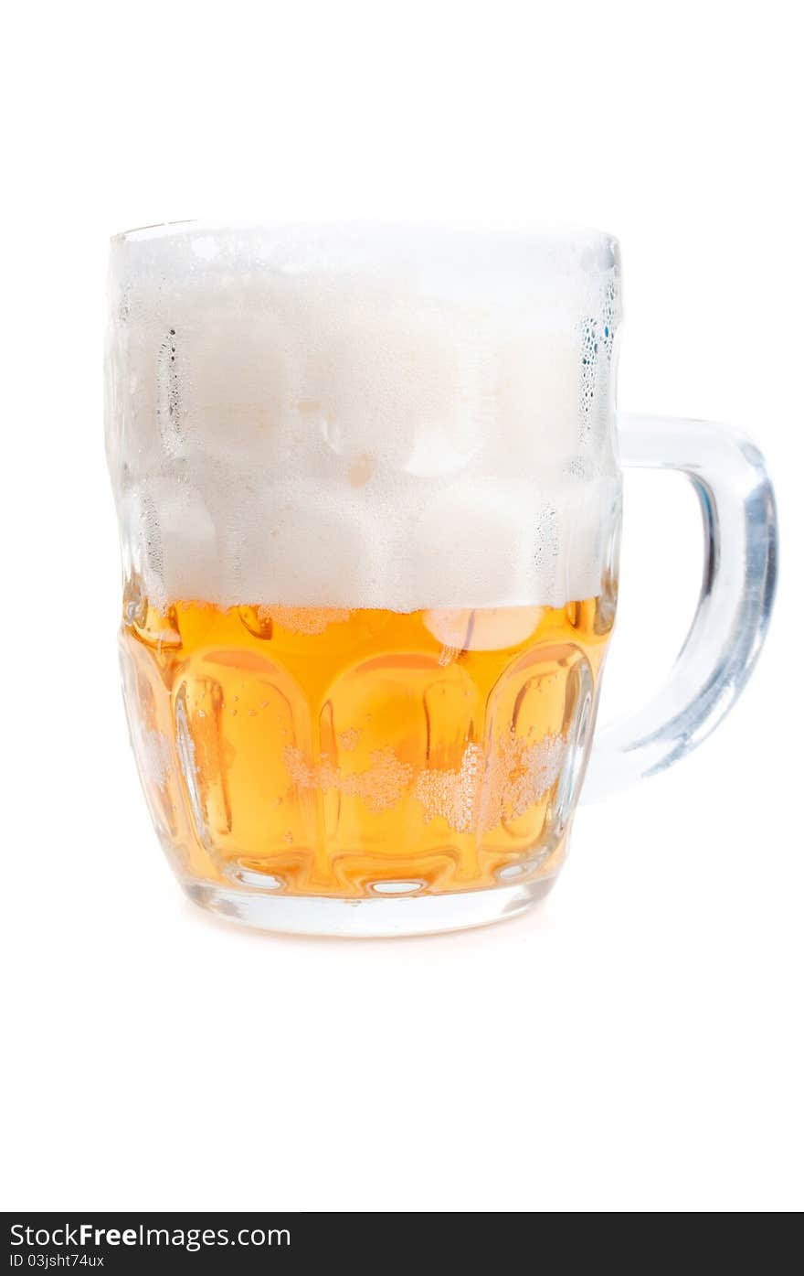 Half-full glass of beer isolated on a white background