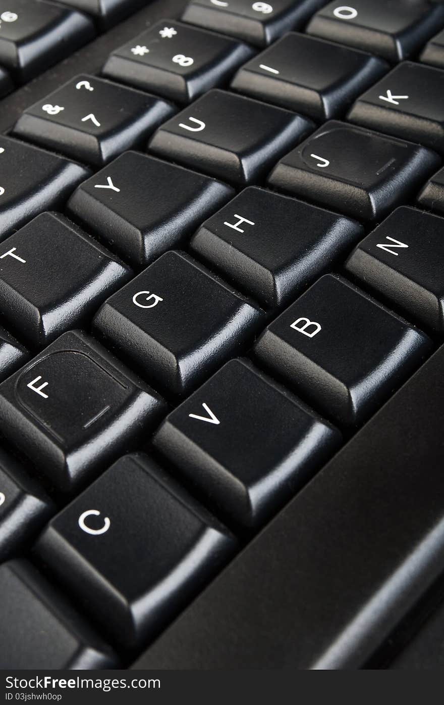 Black computer keyboard closeup on a background