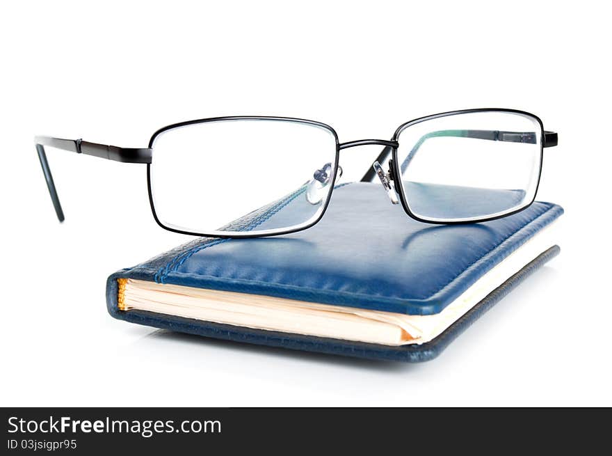 Blue notebook and glasses