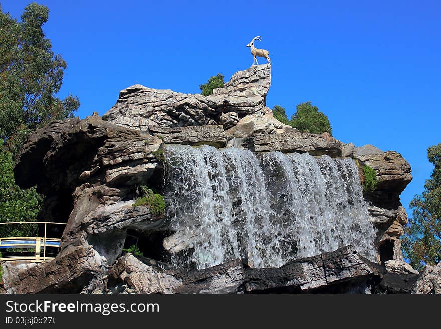 Beautiful waterfall and the goat is on a mountain