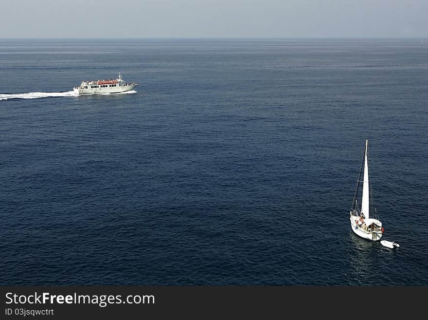 Ocean landscape with two boats driving by