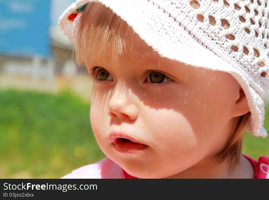 Portrait of the little girl in a hat