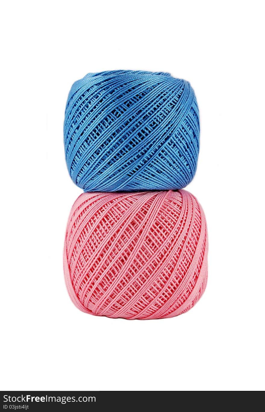 Blue over bigger pink thread ball isolated. Blue over bigger pink thread ball isolated