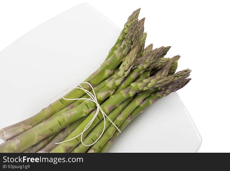 Asparagus on plate, on white background