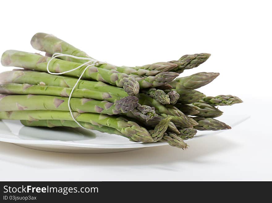 Asparagus on plate, on white background