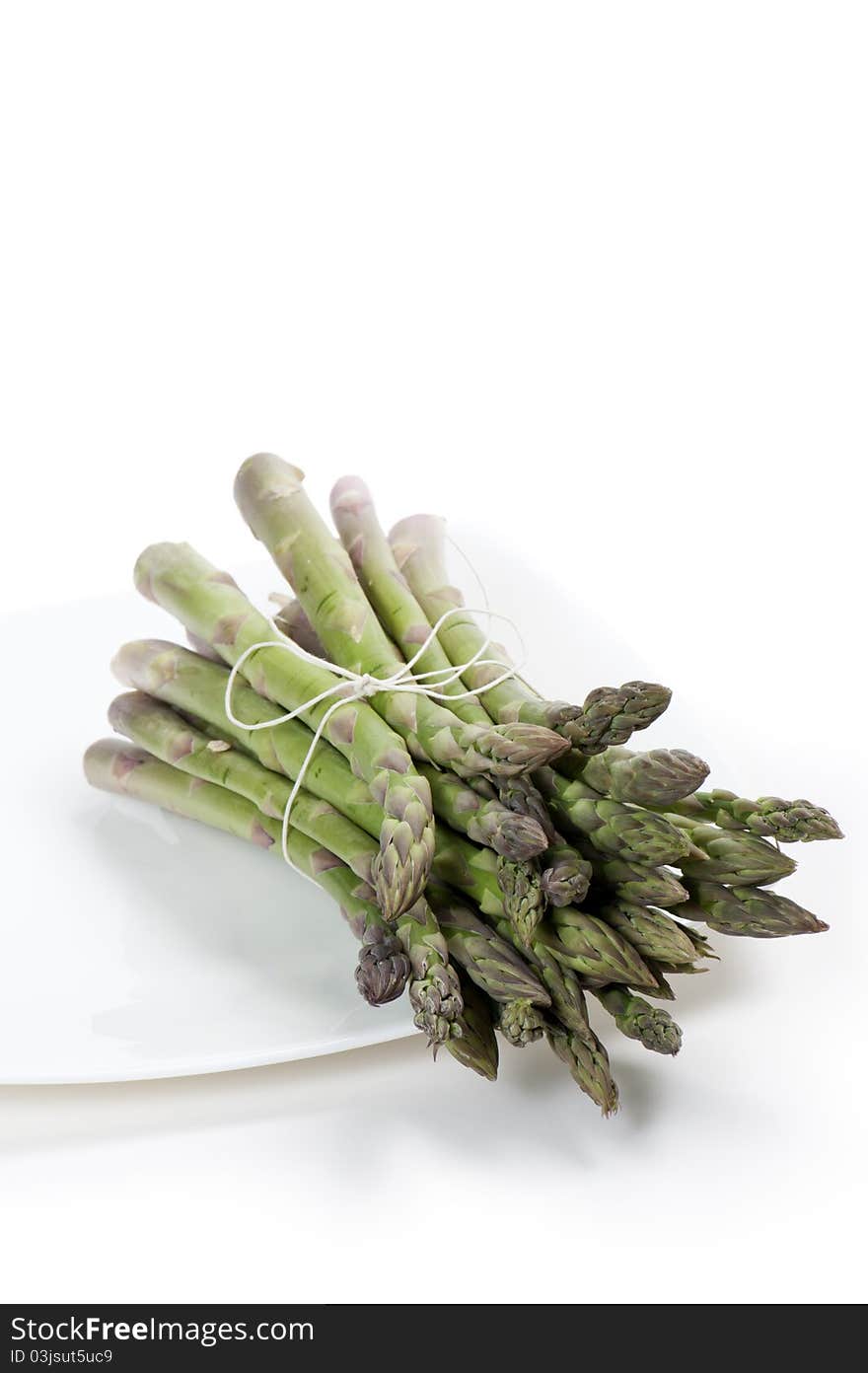 Asparagus on plate, on white background