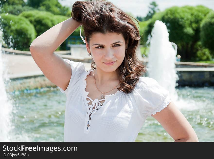 girl at the fountain in summer