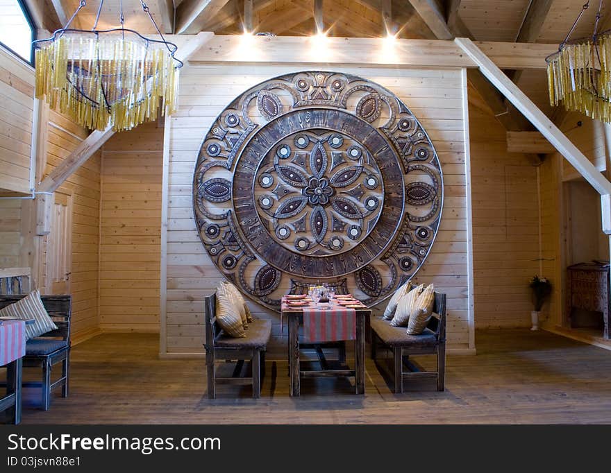 Interior of the restaurant in ethnographic style with the dinner table