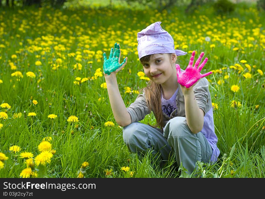 Child painting with paints on the meadow. Child painting with paints on the meadow