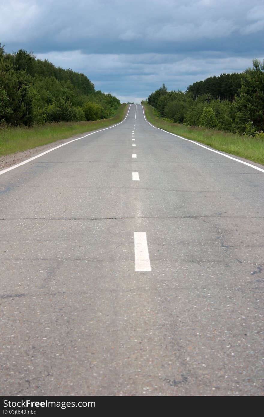 Asphalted highway under the cloudy sky