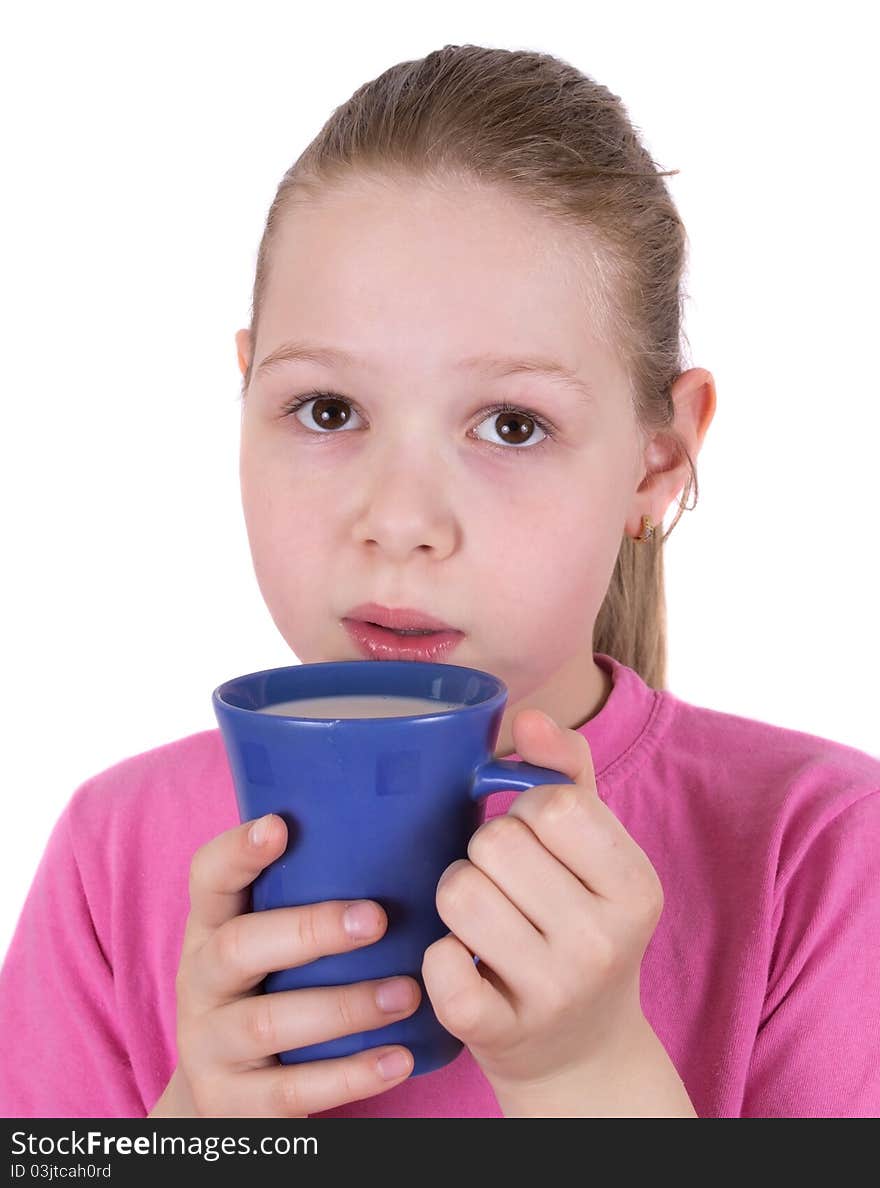 The girl drinks milk from a blue cup isolated