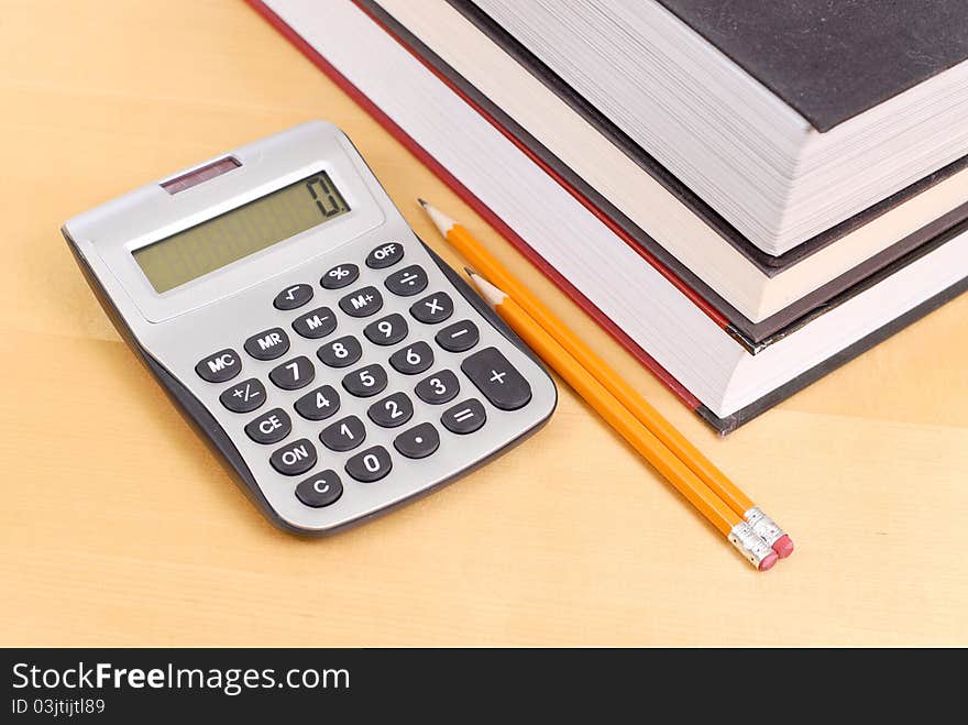 Calculator with Textbooks And Pencils