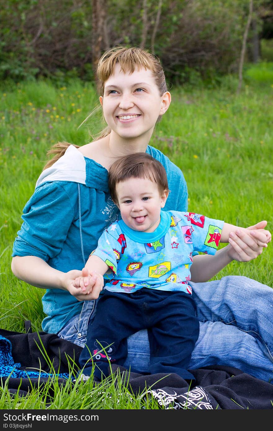 Young mother with son relaxing outdoor. Young mother with son relaxing outdoor