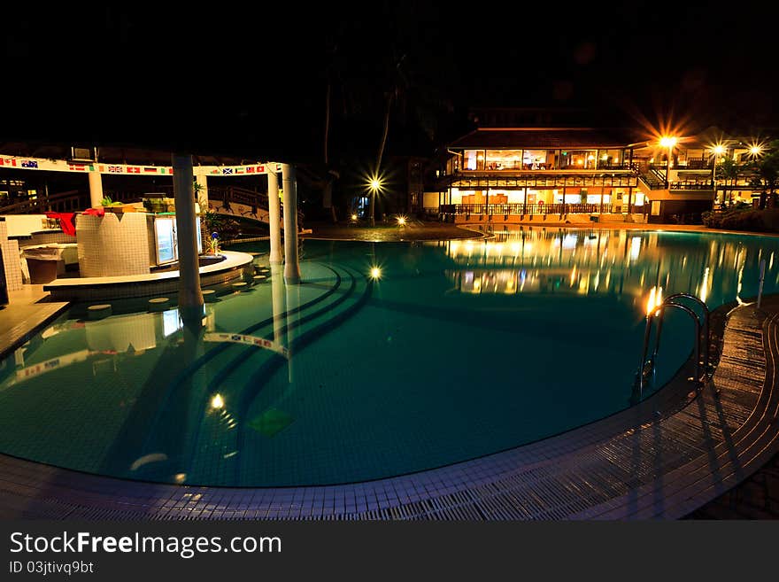 Resort swimming pool with bar at night. Resort swimming pool with bar at night