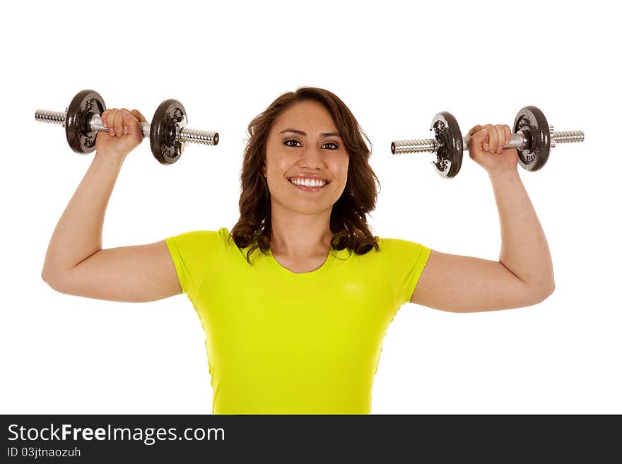 A woman lifting her weights with a huge smile on her face. A woman lifting her weights with a huge smile on her face.