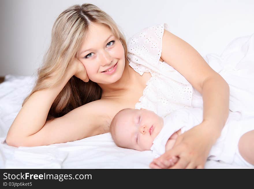 Portrait of a young mother and baby and a girl in her arms