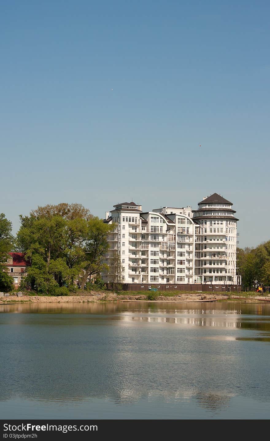 Beautiful building on shore of the blue lake on summer