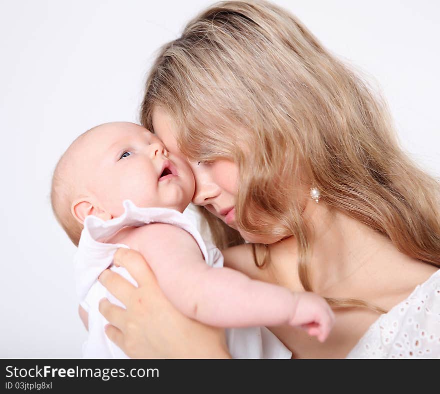 Portrait of a young mother and baby and a girl in her arms