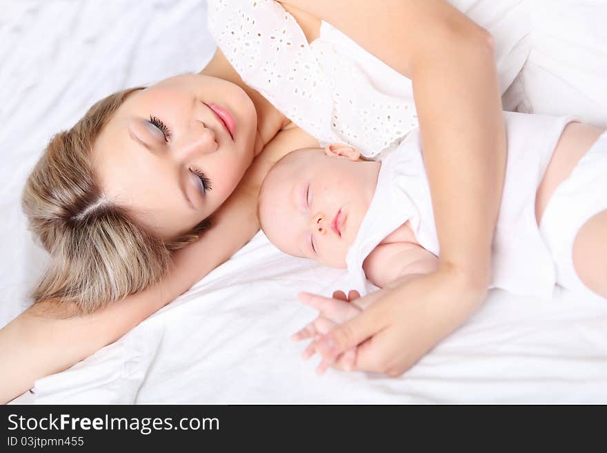 Portrait of a young mother and baby and a girl in her arms