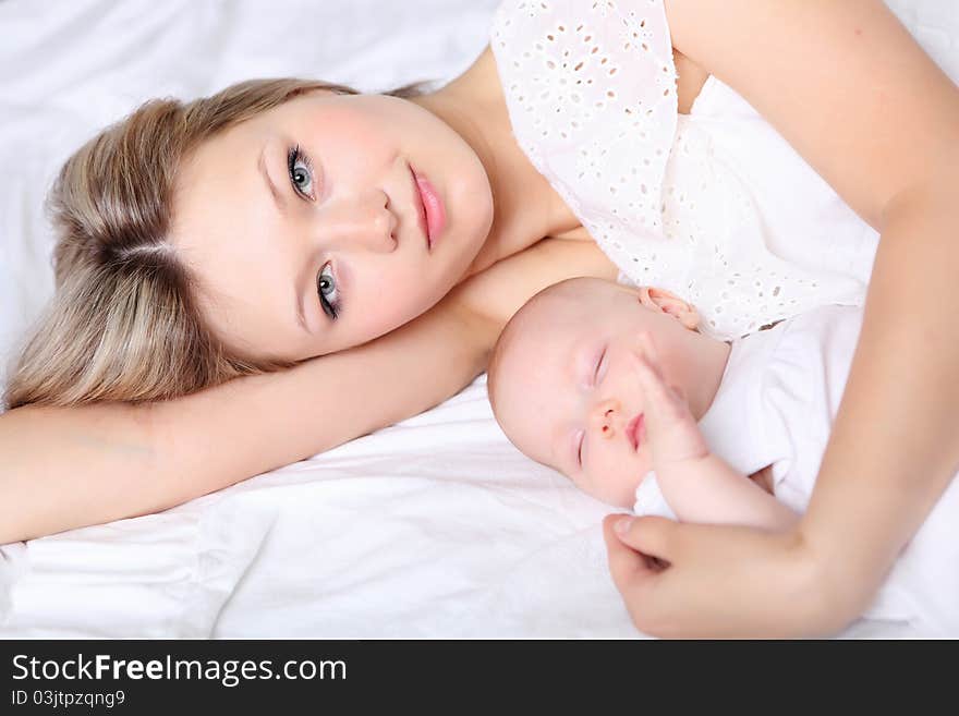 Portrait of a young mother and baby and a girl in her arms