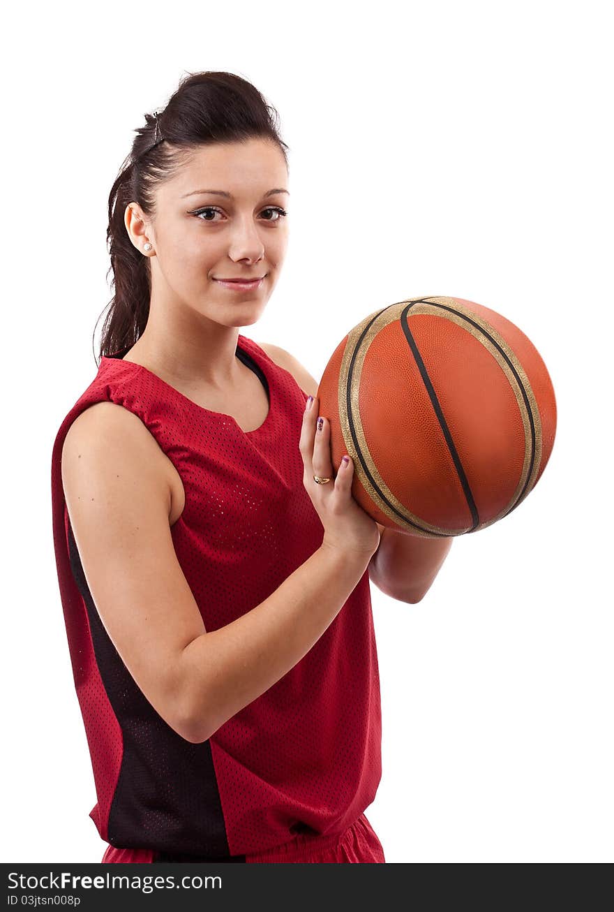 Pretty brunette woman holding basketball in hand and smiling