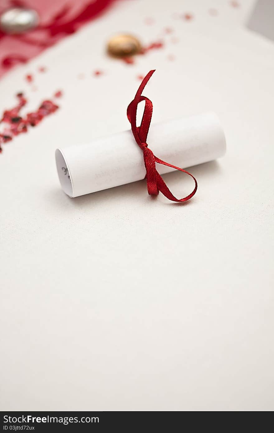 Wedding rolled paper with red ribbon