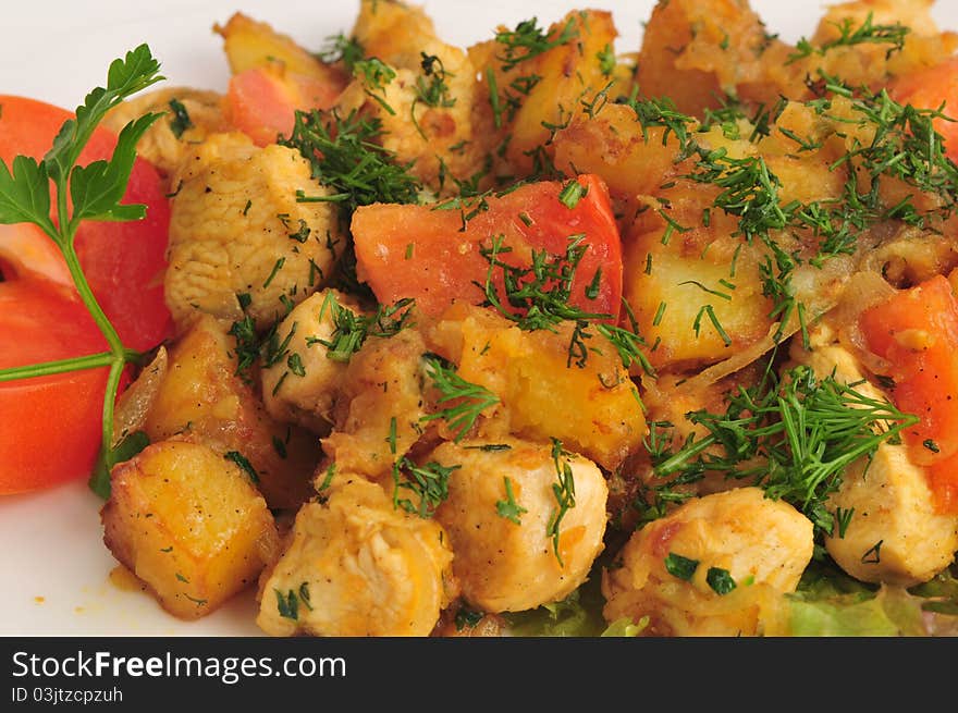 Meat fried with a potato on a white plate