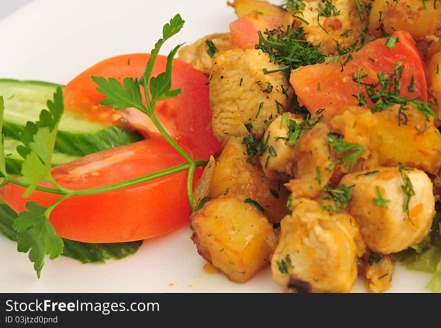 Meat fried with a potato on a white plate