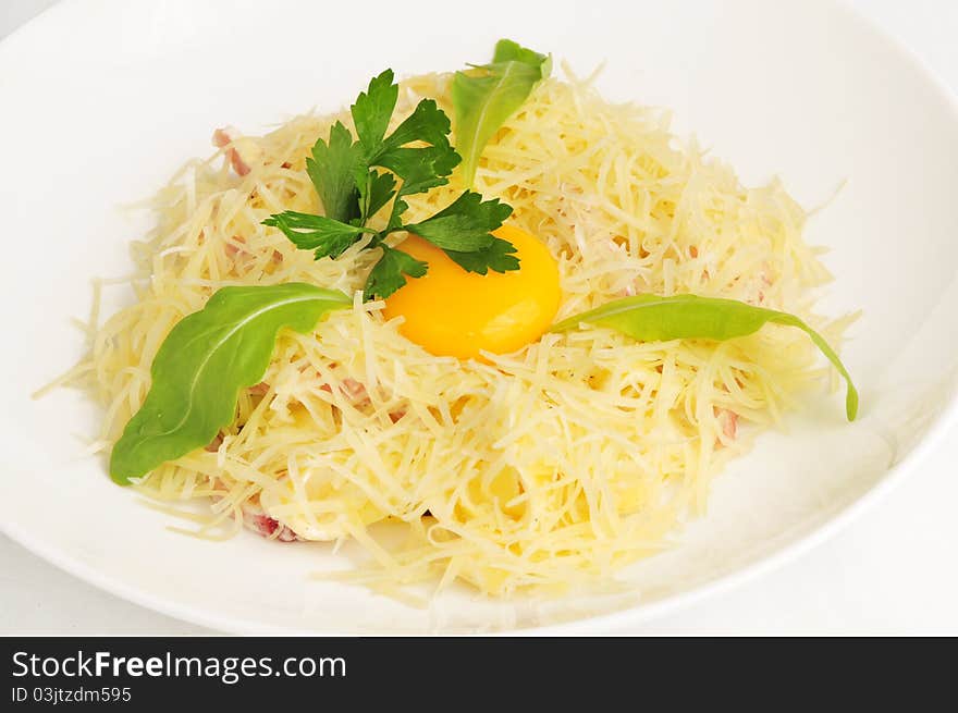 Macaroni baked with fish on a white plate