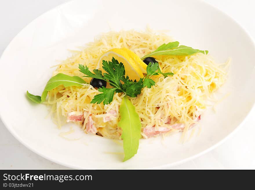 Macaroni baked with fish on a white plate