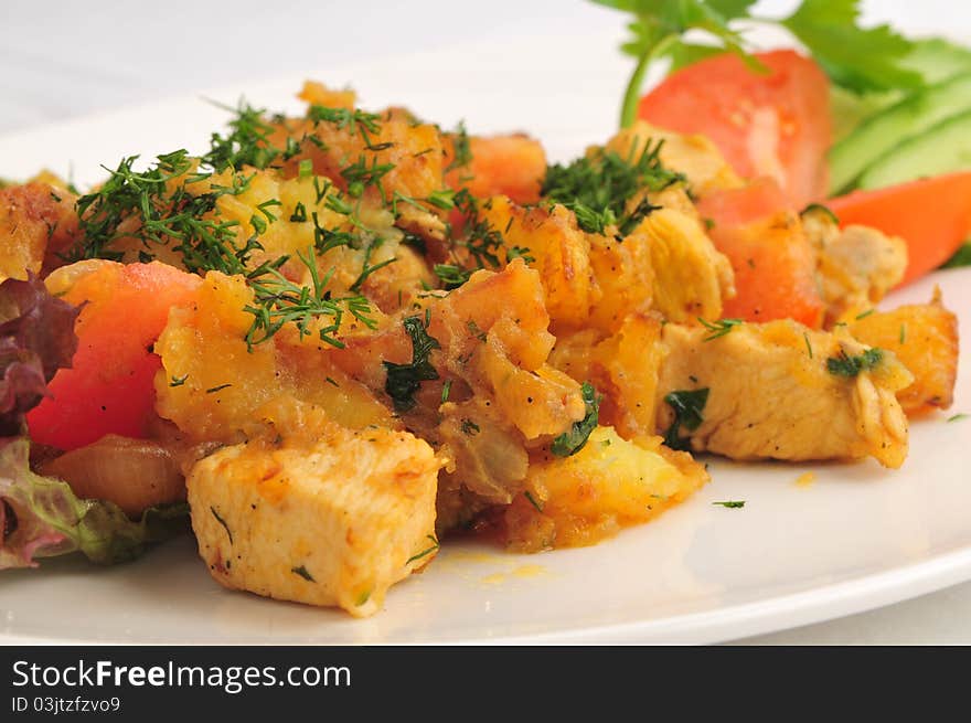 Meat fried with a potato on a white plate