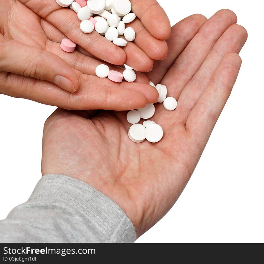 Lot of different pills in the hand. Isolated on white